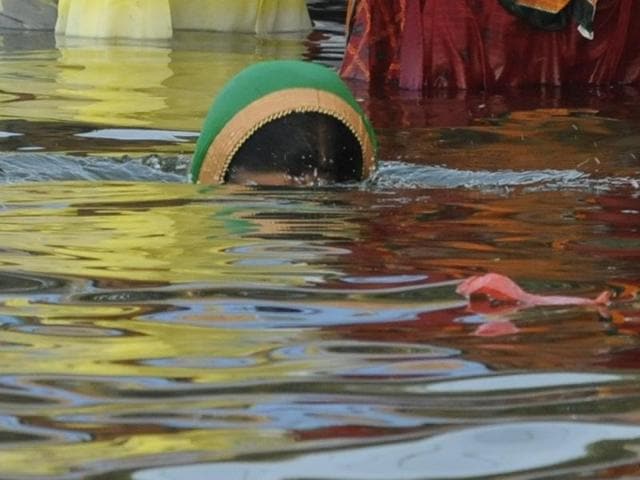 A lady taking a holy dip to pay reverence to Lord Surya . (Mujeeb Faruqui/HT PHOTO) A lady taking a holy dip to pay reverence to Lord Surya . (Mujeeb Faruqui/HT PHOTO)
