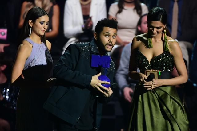 Canadian singer The Weeknd (C) receives the Best Video Award from Bulgarian-Canadian actress Nina Dobrev (L) and Indian film actress Deepika Padukone at the MTV Europe Music Awards (EMA). (AFP) Canadian singer The Weeknd (C) receives the Best Video Award from Bulgarian-Canadian actress Nina Dobrev (L) and Indian film actress Deepika Padukone at the MTV Europe Music Awards (EMA). (AFP)