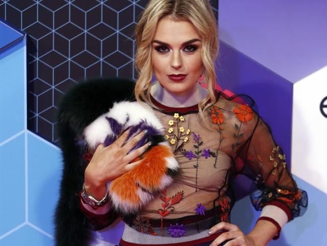 Tallia Storm poses for photographers upon arrival. (AP) Tallia Storm poses for photographers upon arrival. (AP)