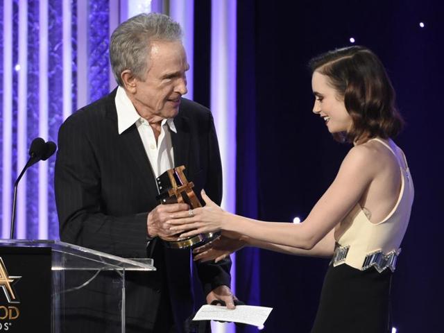 Warren Beatty, left, presents the new Hollywood award to Lily Collins at the 20th annual Hollywood Film Awards at the Beverly Hilton Hotel. (Chris Pizzello/Invision/AP) 