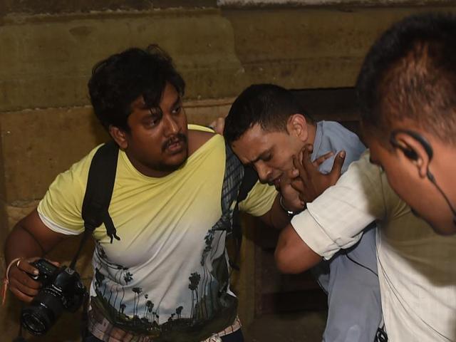 A photojournalist being beaten up by Bombay House security guards on Friday.(HT File Photo)
