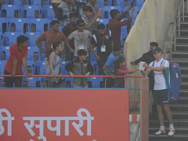 England's cricket captain Alastair Cook signs autographs for fans at the Saurashtra Cricket Association stadium in Rajkot on the eve of the first test match against India. (AFP)