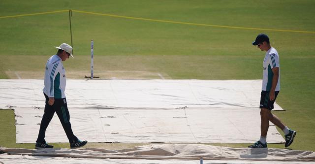 England's cricket coach Trevor Bayliss (L) and captain Alastair Cook inspect the pitch in Rajkot. (AFP)