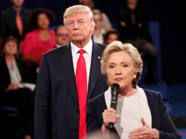 Republican US presidential nominee Donald Trump listens as Democratic nominee Hillary Clinton answers a question from the audience during their presidential town hall debate at Washington University in St. Louis, Missouri. (Reuters File Photo) Republican US presidential nominee Donald Trump listens as Democratic nominee Hillary Clinton answers a question from the audience during their presidential town hall debate at Washington University in St. Louis, Missouri. (Reuters File Photo)