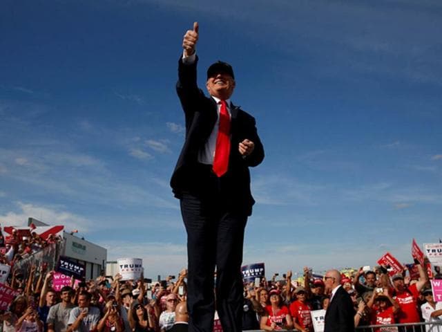 Donald Trump was born in New York on June 14, 1946. He now faces Hillary Clinton in the US presidential election. Here Trump waves to the crowd at a campaign rally. (REUTERS)