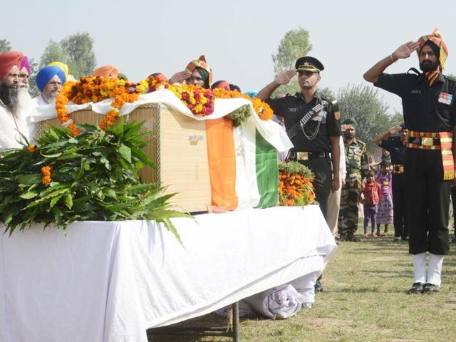 Security personnel and villagers paying their last respects to sepoy Gursewak Singh at his native village of Warana in Tarn Taran on Monday. (Photo: PTI) Security personnel and villagers paying their last respects to sepoy Gursewak Singh at his native village of Warana in Tarn Taran on Monday. (Photo: PTI)