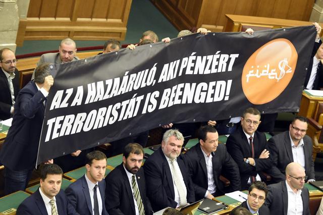 Members of the oppositional Jobbik party holding up the banner which reads: "The traitor is who lets terrorist in for money!" during the vote on the amendment of the Constitution during the plenary session of the parliament in Budapest, Hungary, on November 8, 2016. Hungary's prime minister Viktor Orban has failed in his attempt to push through constitutional amendments to oppose any future plan by the European Union to resettle asylum seekers among members of the bloc. (AP) Members of the oppositional Jobbik party holding up the banner which reads: "The traitor is who lets terrorist in for money!" during the vote on the amendment of the Constitution during the plenary session of the parliament in Budapest, Hungary, on November 8, 2016. Hungary's prime minister Viktor Orban has failed in his attempt to push through constitutional amendments to oppose any future plan by the European Union to resettle asylum seekers among members of the bloc. (AP)