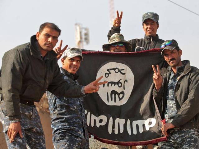 Iraqi soldiers display a captured flag of the Islamic State in the Hamam al-Alil area, about 14 km from the southern outskirts of Mosul on Monday after recapturing it from the jihadist group during the ongoing operation to retake Mosul. (AFP) Iraqi soldiers display a captured flag of the Islamic State in the Hamam al-Alil area, about 14 km from the southern outskirts of Mosul on Monday after recapturing it from the jihadist group during the ongoing operation to retake Mosul. (AFP)
