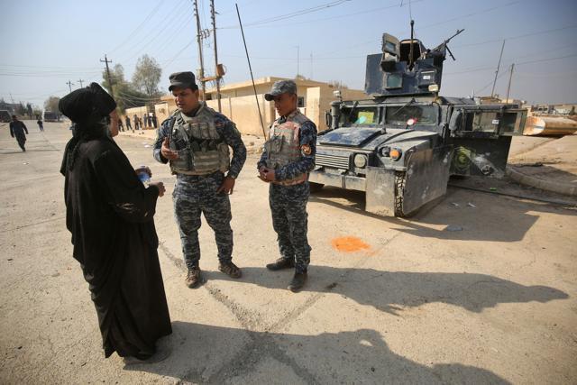 Iraqi soldiers talk to a woman as they patrol the Hamam al-Alil area, about 14km from the southern outskirts of Mosul on Monday after recapturing it from the jihadist group (AFP) Iraqi soldiers talk to a woman as they patrol the Hamam al-Alil area, about 14km from the southern outskirts of Mosul on Monday after recapturing it from the jihadist group (AFP)