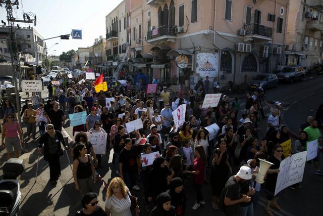 Israeli Arab women hold signs during a demonstration in Jaffa, Israel . (AP Photo) Israeli Arab women hold signs during a demonstration in Jaffa, Israel . (AP Photo)