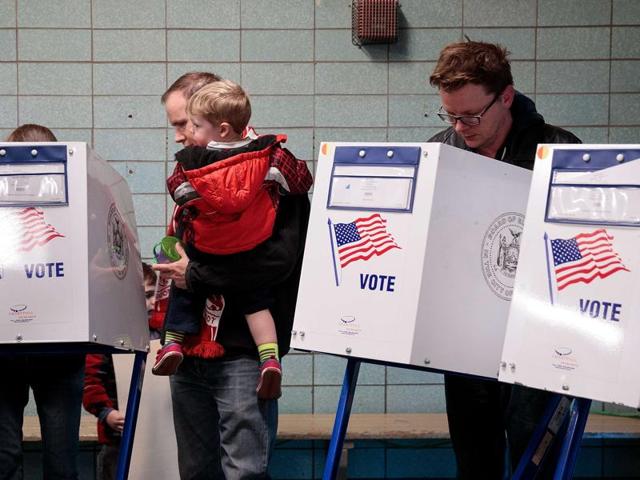 People vote at a polling site at Public School 261, November 8, 2016 in New York City. Citizens of the United States will choose between Republican presidential candidate Donald Trump and Democratic presidential candidate Hillary Clinton. (AFP) People vote at a polling site at Public School 261, November 8, 2016 in New York City. Citizens of the United States will choose between Republican presidential candidate Donald Trump and Democratic presidential candidate Hillary Clinton. (AFP)