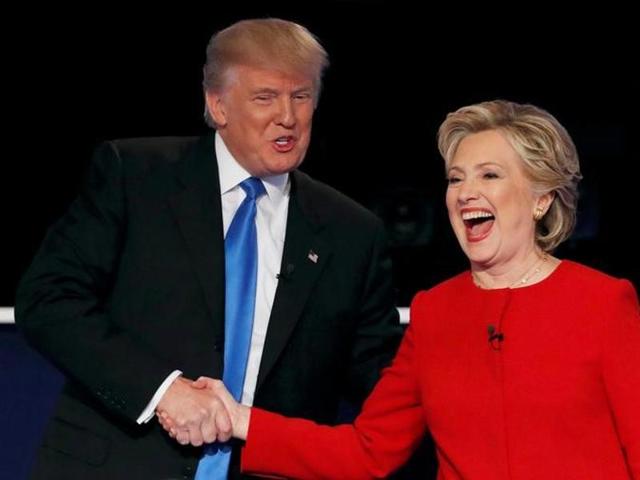 People pose with cutouts of US presidential candidates Hillary Clinton and Donald Trump at a public relations campaign put on by the US Embassy in Dar es Salaam, Tanzania on November 7, 2016.(AFP)