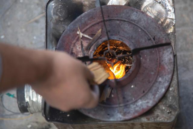 A close up shot shows the metal container with a fan, made by Khaled Kurdiyah in Aleppo's eastern Karam al-Jabal district. (AFP Photo)