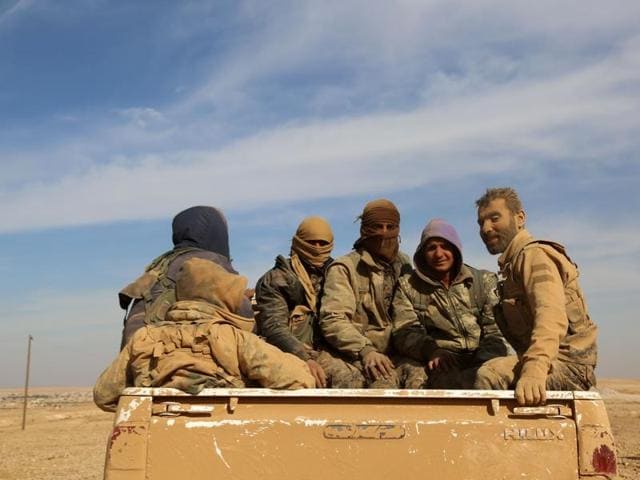 Syrian Democratic Forces (SDF), a US-backed Kurdish-Arab alliance, sit in the back of a truck in the village of Tal Aaj. (AFP Photo) Syrian Democratic Forces (SDF), a US-backed Kurdish-Arab alliance, sit in the back of a truck in the village of Tal Aaj. (AFP Photo)