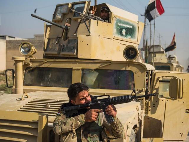 A soldier from the Iraqi army's 9th armoured division aims his weapon as they move around the Al-Intissar neighbourhood of Mosul. (AFP Photo) A soldier from the Iraqi army's 9th armoured division aims his weapon as they move around the Al-Intissar neighbourhood of Mosul. (AFP Photo)
