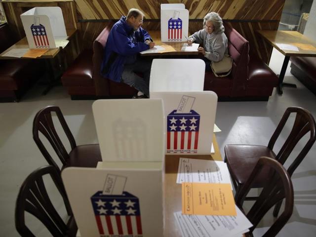 John and Colleen Kramer vote at the Caplinger Mills Trading Post on Tuesday. “If Trump is elected I hope it will come together, if not were gonna have two separate societies in this country,” said John. Colleen, 68, describes herself as an independent. She says she wouldn’t mind voting for a female president — just not the one currently on the ballot. (AP) John and Colleen Kramer vote at the Caplinger Mills Trading Post on Tuesday. “If Trump is elected I hope it will come together, if not were gonna have two separate societies in this country,” said John. Colleen, 68, describes herself as an independent. She says she wouldn’t mind voting for a female president — just not the one currently on the ballot. (AP)