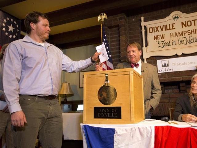 Dixville Notche's first voter Clay Smith drops his ballot into the box as moderator Tom Tillotson watches in Dixville Notch, New Hampshire. Democratic candidate Hillary Clinton beat Republican Donald Trump 4-2. (AP) Dixville Notche's first voter Clay Smith drops his ballot into the box as moderator Tom Tillotson watches in Dixville Notch, New Hampshire. Democratic candidate Hillary Clinton beat Republican Donald Trump 4-2. (AP)