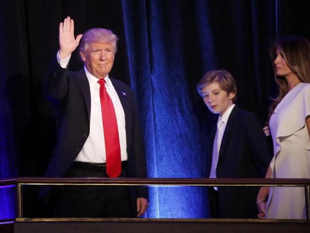US Republican presidential nominee Donald Trump arrives to speak at his election night rally with his son Barron and wife Melania in Manhattan, New York.(Reuters Photo)