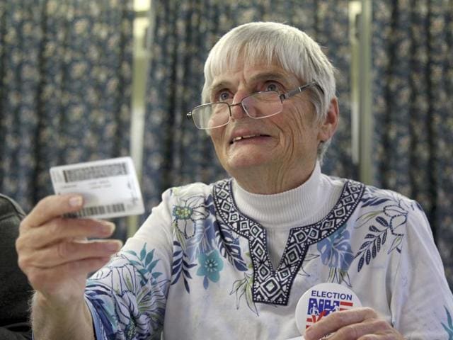 Ballot clerk Patricia Timbury checks a voter's identification during the U.S. presidential election in Woodstock, New Hampshire. (REUTERS) Ballot clerk Patricia Timbury checks a voter's identification during the U.S. presidential election in Woodstock, New Hampshire. (REUTERS)