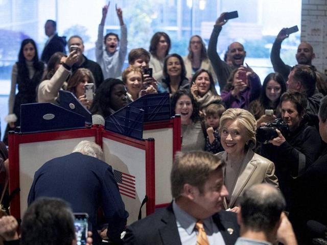 Democratic presidential candidate Hillary Clinton, accompanied by her husband, former President Bill Clinton, left, smiles as she votes at Douglas G. Grafflin School in Chappaqua, New York, on November 8. At far left is senior aide Huma Abedin. (AP) Democratic presidential candidate Hillary Clinton, accompanied by her husband, former President Bill Clinton, left, smiles as she votes at Douglas G. Grafflin School in Chappaqua, New York, on November 8. At far left is senior aide Huma Abedin. (AP)