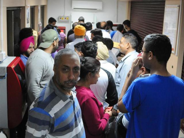 People in queue at an ATM-cash deposit kiosk with notes of Rs 500 and 1,000 in Phase 7, SAS Nagar (Mohali), on Tuesday. (Anil dayal/HT Photo) People in queue at an ATM-cash deposit kiosk with notes of Rs 500 and 1,000 in Phase 7, SAS Nagar (Mohali), on Tuesday. (Anil dayal/HT Photo)