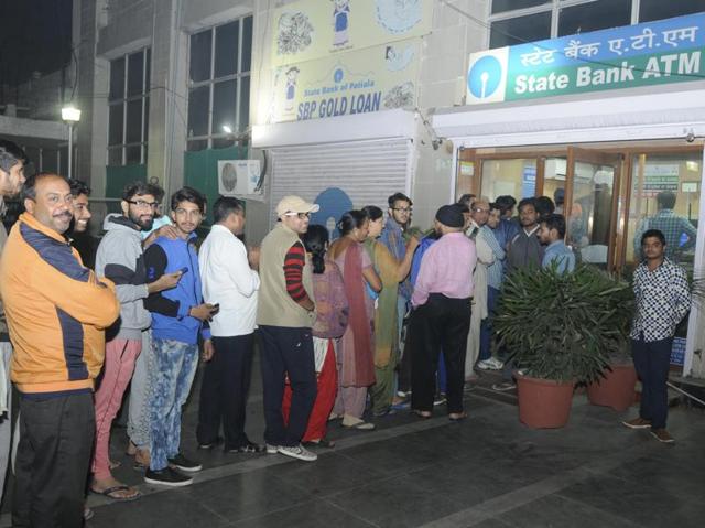 People in queue at an ATM to withdraw Rs 100 notes, or to deposit notes of Rs 500 and 1,000 through the machines, in Patiala on Tuesday. (Bharat Bhushan/HT Photo) People in queue at an ATM to withdraw Rs 100 notes, or to deposit notes of Rs 500 and 1,000 through the machines, in Patiala on Tuesday. (Bharat Bhushan/HT Photo)