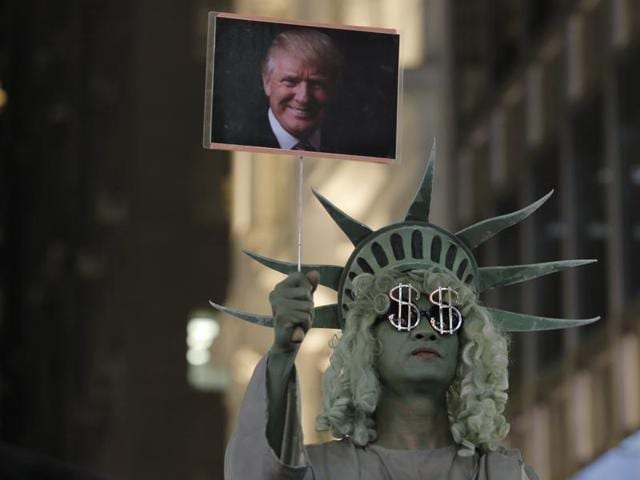 A traditional wooden Matryoshka doll depicting US president-elect Donald Trump is displayed at a shop in Kiev, Ukraine, Wednesday, November 9, 2016.(AP)