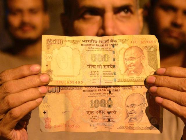 Indian residents queue to deposit money in a Cash Deposit Kiosk in Siliguri. Prime Minister Narendra Modi announced late November 8 that 500 and 1,000 rupee notes will be withdrawn from financial circulation from midnight, in a bid to tackle corruption. (AFP) Indian residents queue to deposit money in a Cash Deposit Kiosk in Siliguri. Prime Minister Narendra Modi announced late November 8 that 500 and 1,000 rupee notes will be withdrawn from financial circulation from midnight, in a bid to tackle corruption. (AFP)