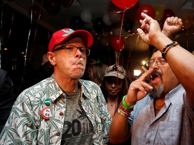 William Britt (left) and Al Moreno (right) celebrate after Californians voted to pass Prop 64, legalizing recreational use of marijuana in the state, in Los Angeles, California. (Reuters Photo)