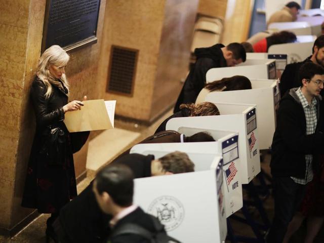 Yoana Baraschi, left, looks over a ballot while waiting for a machine to open up to vote in the Chelsea neighborhood of New York. "We all have a conscience and if we look at what brings light into our life, it'll be easier. We all have it," said Baraschi when asked what she feels could bring the country together after the election. (AP) Yoana Baraschi, left, looks over a ballot while waiting for a machine to open up to vote in the Chelsea neighborhood of New York. "We all have a conscience and if we look at what brings light into our life, it'll be easier. We all have it," said Baraschi when asked what she feels could bring the country together after the election. (AP)