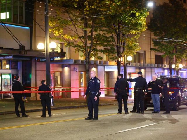 Law enforcement officers canvas the scene of a multiple victim shooting near Third Avenue and Pike Street in downtown Seattle. (AP Photo) Law enforcement officers canvas the scene of a multiple victim shooting near Third Avenue and Pike Street in downtown Seattle. (AP Photo)