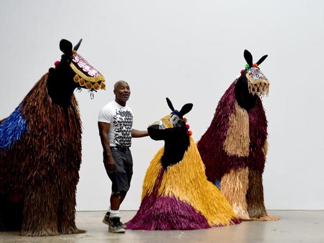 Under each suit, two dancers hold and control the puppet with their choreographed movements. (AFP) 