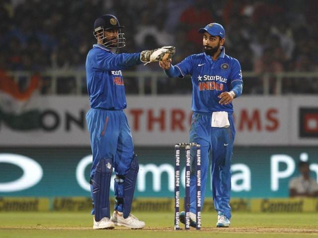 India's captain Mahendra Singh Dhoni, left, and teammate Virat Kohli direct fielders to take their positions during their fifth and last one day international cricket match against New Zealand in Visakhapatnam, India, Saturday, Oct. 29, 2016. (AP Photo/Aijaz Rahi)(AP)