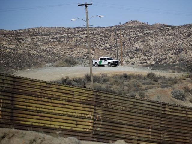 A Border Patrol vehicle sits on a hill in Tecate, Calif., seen behind the metal barrier that lines the border in Tecate, Mexico. As a candidate, president elect Trump has suggested slapping a 35 percent tax on automobiles and auto parts made by US companies in Mexico, and financial analysts have predicted that the Trump win will threaten billions of dollars in cross-border trade. (AP Photo) A Border Patrol vehicle sits on a hill in Tecate, Calif., seen behind the metal barrier that lines the border in Tecate, Mexico. As a candidate, president elect Trump has suggested slapping a 35 percent tax on automobiles and auto parts made by US companies in Mexico, and financial analysts have predicted that the Trump win will threaten billions of dollars in cross-border trade. (AP Photo)