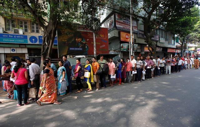 People stand in queue as they wait to enter a bank in Kolkata. (Reuters Photo) People stand in queue as they wait to enter a bank in Kolkata. (Reuters Photo)