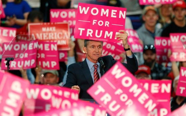 Retired Lt. General Michael Flynn holds up a sign while speaking to the crowd gathered to see US Republican presidential candidate Donald Trump at The Champions Center Expo in Springfield, Ohio, on October 27, 2016. (AFP Photo)
