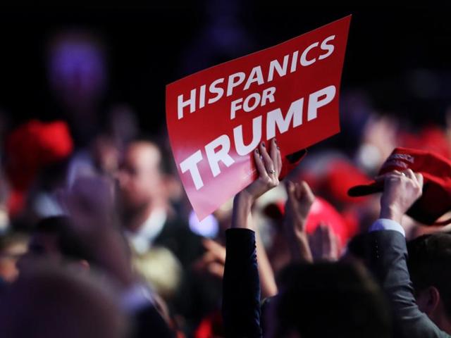 An attendee holds up a sign in support of Donald Trump that reads "Hispanics For Trump" during the election night event on November 8.(AFP Photo)