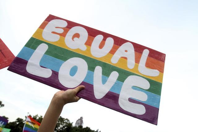 A participant holds a placard during a gay and lesbian parade in Taipei, Taiwan (AP File Photo) A participant holds a placard during a gay and lesbian parade in Taipei, Taiwan (AP File Photo)