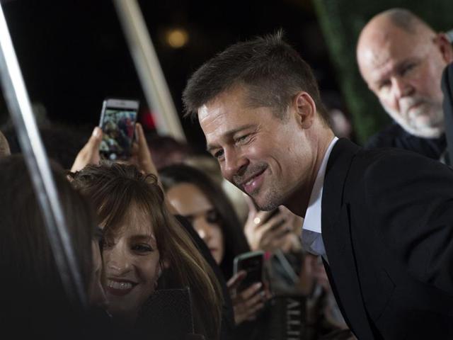 Actor Brad Pitt clicks pictures with his fans at a screening of his new World War II thriller Allied. (AFP) Actor Brad Pitt clicks pictures with his fans at a screening of his new World War II thriller Allied. (AFP)