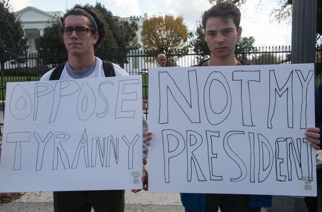 Protestors hold signs against US President-elect Donald Trump on Wednesday in front of the White House in Washington, DC. (AFP Photo) Protestors hold signs against US President-elect Donald Trump on Wednesday in front of the White House in Washington, DC. (AFP Photo)