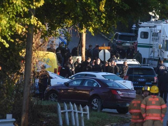 Law enforcement personnel gather after a nearby shooting in Canonsburg, Pennsylvania on Thursday. Multiple western Pennsylvania police officers were "ambushed" and shot while responding to a domestic situation, authorities said. (AP) Law enforcement personnel gather after a nearby shooting in Canonsburg, Pennsylvania on Thursday. Multiple western Pennsylvania police officers were "ambushed" and shot while responding to a domestic situation, authorities said. (AP)