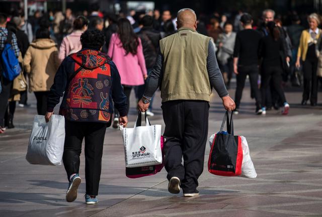 The day is a welcome sign to the country’s leaders, who are working to transform the economy to consumer-orientated. A couple carries shopping bags on the main shopping street at West Nanjing Road, during the 'Double Eleven' Online Shopping Festival day in Shanghai. (AFP Photo) The day is a welcome sign to the country’s leaders, who are working to transform the economy to consumer-orientated. A couple carries shopping bags on the main shopping street at West Nanjing Road, during the 'Double Eleven' Online Shopping Festival day in Shanghai. (AFP Photo)