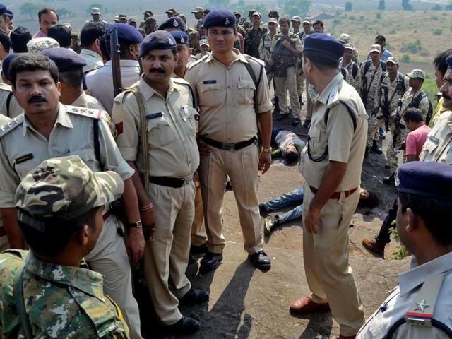 Police officers and special task force soldiers stand beside the bodies of the suspected members of the banned Students Islamic Movement of India (SIMI), who escaped the high security jail in Bhopal, and later got killed in an encounter at the Acharpura village on the outskirts of Bhopal on October 31, 2016.(Reuters file photo)