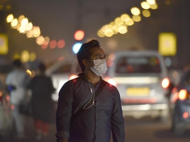 A man wears a mask as he walks in New Delhi.(Raj K Raj/HT File Photo)