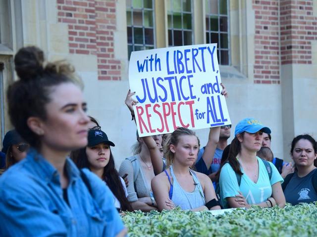 University of California Los Angeles students hold signs and listen to speeches before marching through campus on Thursday during a "Love Trumps Hate" rally.(AFP Photo)