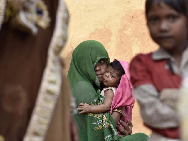 Halku Adivasi’s 15-month-old son Anil died of severe malnutrition last Tuesday, following which his second son was given BCG and DPT vaccines together. “He hasn’t stopped crying since he was vaccinated, what have you done to him?” his distraught wife Anjana asks the aganwadi worker in their home in Kalarna village in Sheopur district in Madhya Pradesh. The anganwadi worker forgot to tell them the baby will have pain and mild fever for a day or two following vaccination, in Madhya November 9. (Photo by Virendra Singh Gosain/ Hindustan Times) Halku Adivasi’s 15-month-old son Anil died of severe malnutrition last Tuesday, following which his second son was given BCG and DPT vaccines together. “He hasn’t stopped crying since he was vaccinated, what have you done to him?” his distraught wife Anjana asks the aganwadi worker in their home in Kalarna village in Sheopur district in Madhya Pradesh. The anganwadi worker forgot to tell them the baby will have pain and mild fever for a day or two following vaccination, in Madhya November 9. (Photo by Virendra Singh Gosain/ Hindustan Times)