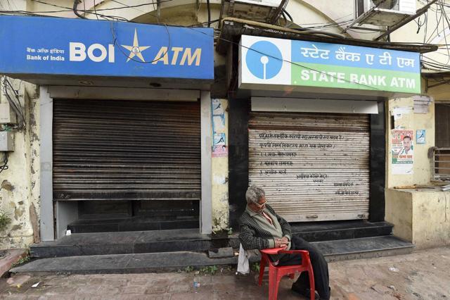 A guard takes a nap in front of closed ATM counters in Lucknow. (PTI Photo) A guard takes a nap in front of closed ATM counters in Lucknow. (PTI Photo)