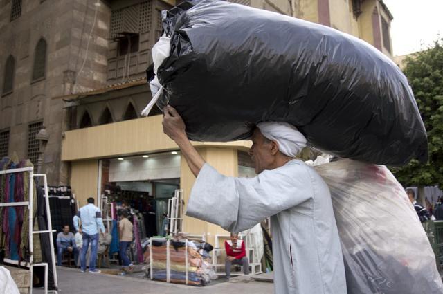An Egyptian street vendor walks on El-Moez Street in Fatimid Cairo, Egypt. (AP) An Egyptian street vendor walks on El-Moez Street in Fatimid Cairo, Egypt. (AP)
