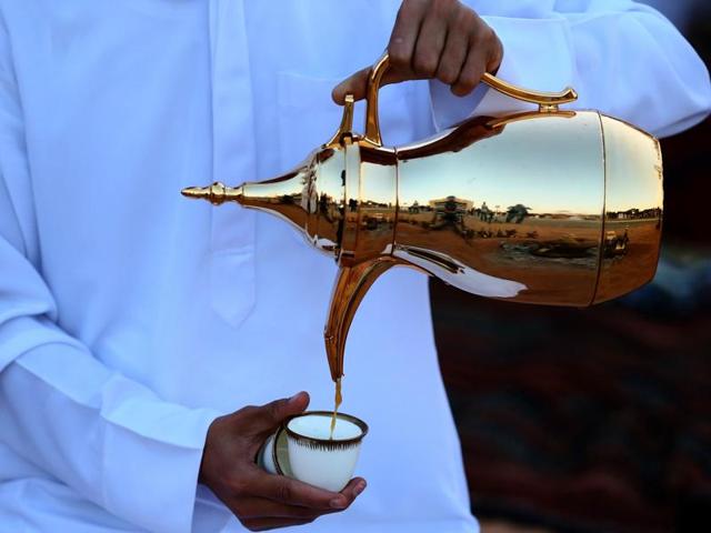 An Emirati man serves coffee during the festival. Through major part of mid-20th century, camel herding, production of dates, vegetables, fishing and pearl diving were the main stay of its economy. Oil was first found in 1958. (AFP) An Emirati man serves coffee during the festival. Through major part of mid-20th century, camel herding, production of dates, vegetables, fishing and pearl diving were the main stay of its economy. Oil was first found in 1958. (AFP)