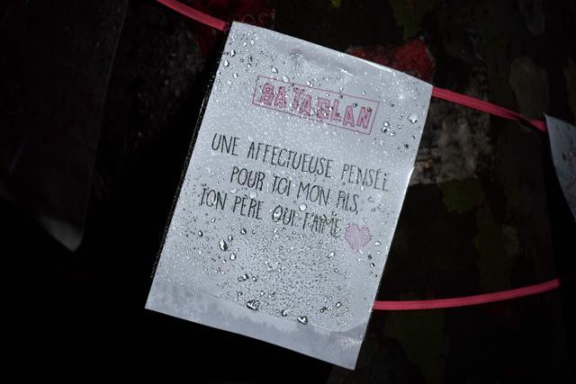 A placard reading " Bataclan. An affectionate thought for you my son, your father who loves you" is hung around a tree near the Bataclan concert hall in Paris. (AFP Photo)